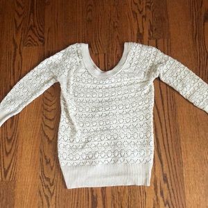 Cream colored sweater.